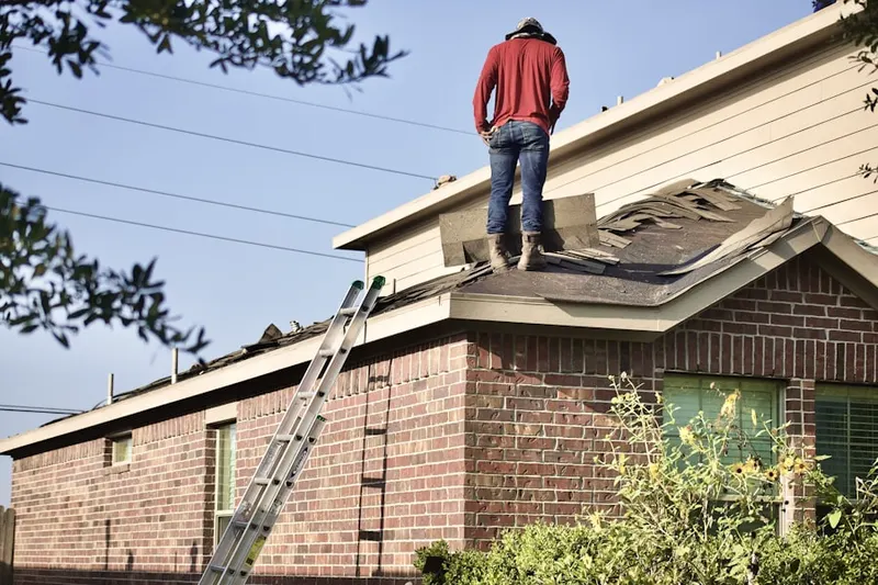 Professional roofer working on a residential roof in Lakewood Villas